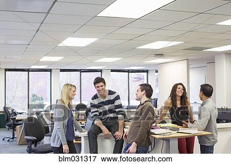 Stock Photo - Business people talking in office. Fotosearch