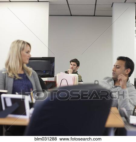 Stock Photo - Business people working in office. Fotosearch