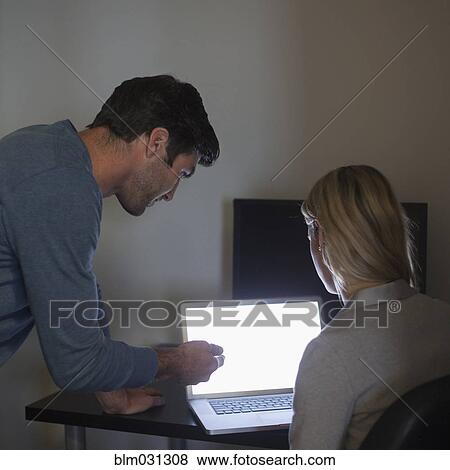 Stock Photo - Business people working together in office. Fotosearch