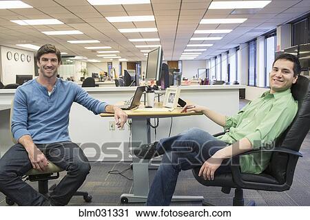 Businessmen smiling in office View Large Photo Image Stock Image - Businessmen smiling in office. Fotosearch