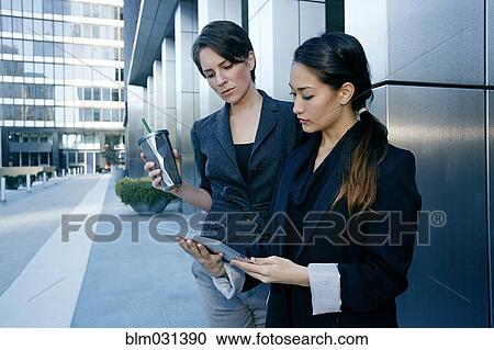 Businesswomen using tablet computer in city View Large Photo Image Stock Image - Businesswomen using tablet computer in city. Fotosearch