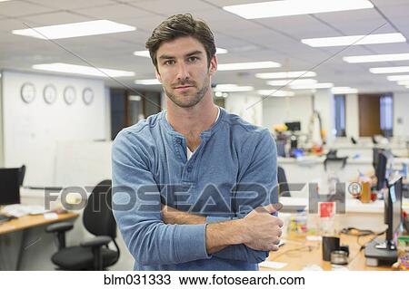 Caucasian businessman standing in office View Large Photo Image Stock Image - Caucasian businessman standing in office. Fotosearch