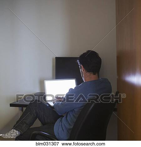 Caucasian businessman using laptop in office View Large Photo Image Stock Photo - Caucasian businessman using laptop in office. Fotosearch