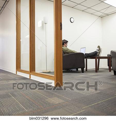 Stock Photograph - Caucasian businessman working in office. Fotosearch