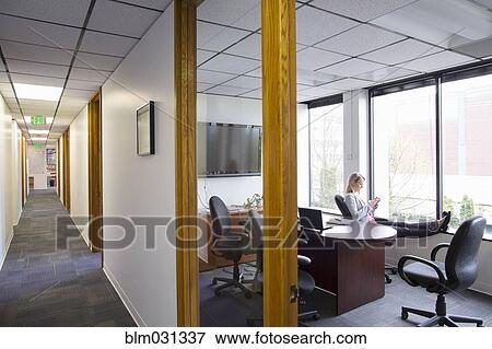 Stock Photo - Caucasian businesswoman sitting in office. Fotosearch