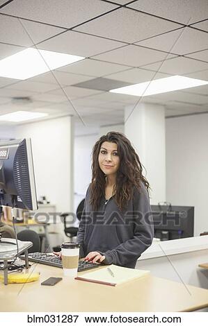Caucasian businesswoman smiling in office View Large Photo Image Stock Photo - Caucasian businesswoman smiling in office. Fotosearch