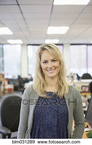 Stock Photo - Caucasian businesswoman smiling in office. Fotosearch