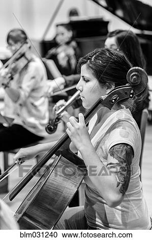 Caucasian student playing cello in college orchestra View Large Photo Image Stock Image - Caucasian student playing cello in college orchestra. Fotosearch