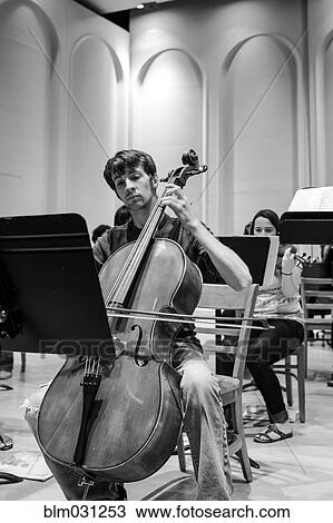 Caucasian student playing cello in college orchestra View Large Photo Image Stock Image - Caucasian student playing cello in college orchestra. Fotosearch
