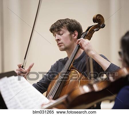Caucasian student playing cello in string quartet View Large Photo Image Stock Photography - Caucasian student playing cello in string quartet. Fotosearch
