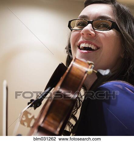 Stock Image - Caucasian student playing violin. Fotosearch