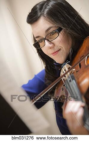 Stock Photograph - Close up of student playing violin. Fotosearch