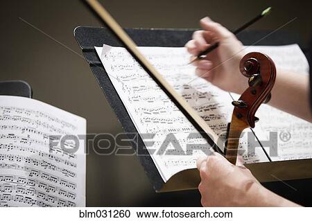 Close up of student writing on sheet music View Large Photo Image Stock Image - Close up of student writing on sheet music. Fotosearch