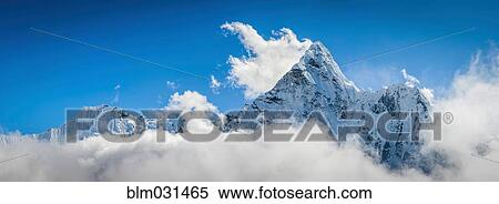 Stock Photography - Clouds surrounding snowy mountaintops, Tengboche, Khumbu, Nepal. Fotosearch
