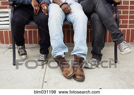 Stock Photo - Friends' feet on city street. Fotosearch