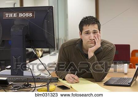 Hispanic businessman thinking at desk in office View Large Photo Image Stock Image - Hispanic businessman thinking at desk in office. Fotosearch