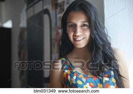 Hispanic woman smiling indoors View Large Photo Image Stock Photo - Hispanic woman smiling indoors. Fotosearch