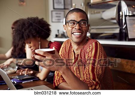 Man having cup of coffee in cafe View Large Photo Image Stock Photo - Man having cup of coffee in cafe. Fotosearch