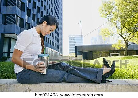 Stock Photo - Mixed race businesswoman using tablet computer in city. Fotosearch