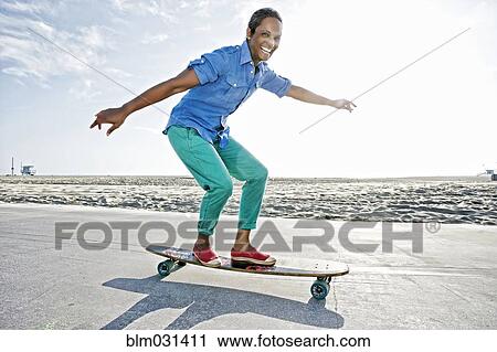 Older Black woman skateboarding by beach View Large Photo Image Stock Image - Older Black woman skateboarding by beach. Fotosearch