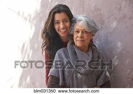 Older Hispanic woman and granddaughter smiling View Large Photo Image Stock Image - Older Hispanic woman and granddaughter smiling. Fotosearch