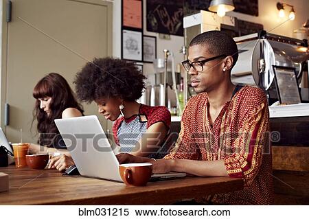 People using technology in coffee shop View Large Photo Image Stock Photography - People using technology in coffee shop. Fotosearch