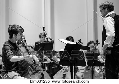 Stock Photography - Professor conducting college orchestra. Fotosearch