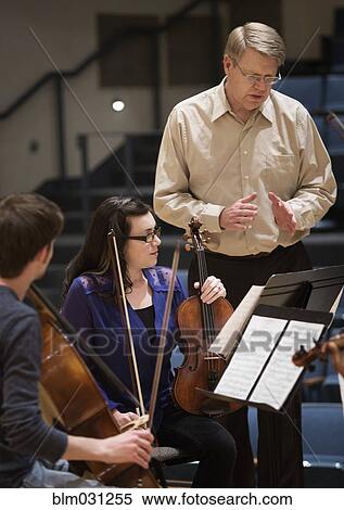 Professor instructing college string quartet View Large Photo Image Stock Photography - Professor instructing college string quartet. Fotosearch