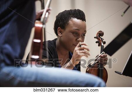Stock Photo - Student playing violin in string quartet. Fotosearch