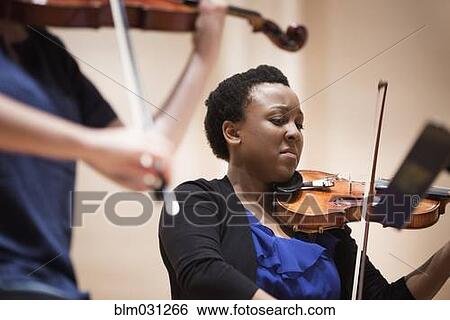 Stock Photograph - Student playing violin in string quartet. Fotosearch