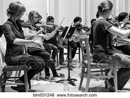 Stock Photo - Students playing in college orchestra. Fotosearch