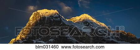 Sun setting over snowy mountaintop, Lukla, Khumbu, Nepal View Large Photo Image Stock Image - Sun setting over snowy mountaintop, Lukla, Khumbu, Nepal. Fotosearch
