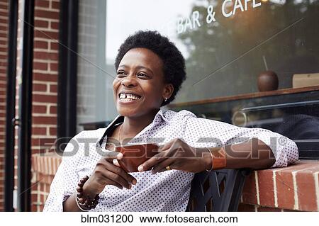 Woman drinking coffee on city street View Large Photo Image Stock Image - Woman drinking coffee on city street. Fotosearch