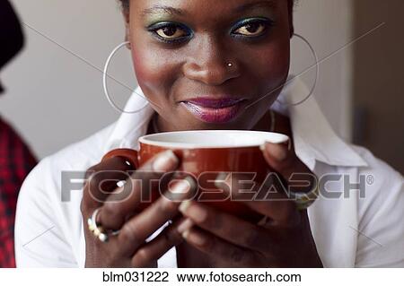 Stock Image - Woman having cup of coffee in cafe. Fotosearch