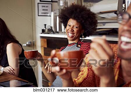 Stock Photo - Woman laughing in cafe. Fotosearch