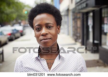 Woman standing on city street View Large Photo Image Stock Image - Woman standing on city street. Fotosearch
