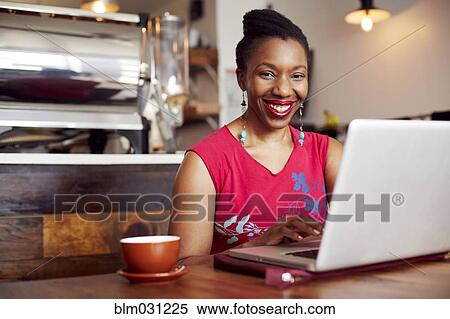 Woman using laptop in cafe View Large Photo Image Stock Photography - Woman using laptop in cafe. Fotosearch