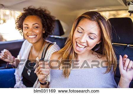 Women dancing together in car View Large Photo Image Stock Photo - Women dancing together in car. Fotosearch