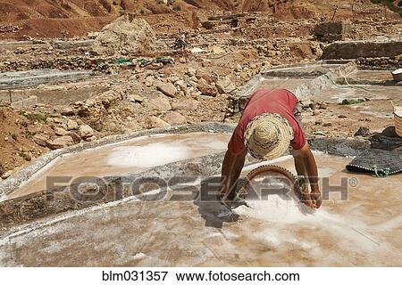 Stock Photo - Worker scooping sand in quarry. Fotosearch
