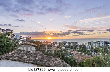 Stock Photo - Aerial view of city rooftops, sunrise and horizon, Puerto Vallarta, Jalisco, Mexico. Fotosearch