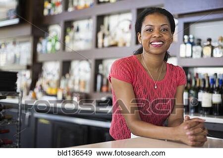 African American bartender smiling in bar View Large Photo Image Stock Photo - African American bartender smiling in bar. Fotosearch