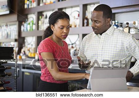 African American couple using tablet computer in restaurant View Large Photo Image Stock Image - African American couple using tablet computer in restaurant. Fotosearch