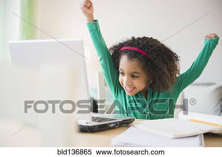 African American girl cheering at laptop View Large Photo Image Stock Photography - African American girl cheering at laptop. Fotosearch
