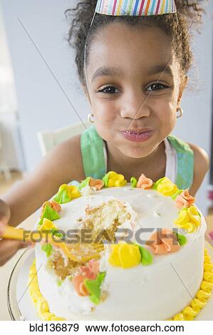 African American girl eating birthday cake View Large Photo Image Stock Photo - African American girl eating birthday cake. Fotosearch