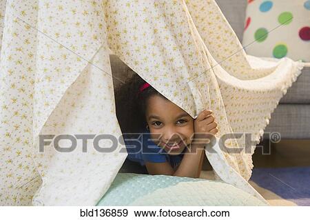 African American girl playing in blanket fort View Large Photo Image Stock Photo - African American girl playing in blanket fort. Fotosearch