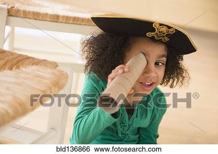 Stock Photograph - African American girl playing with cardboard tube. Fotosearch