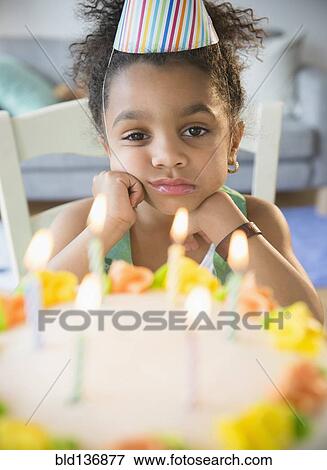 African American girl pouting at birthday cake View Large Photo Image Stock Photo - African American girl pouting at birthday cake. Fotosearch