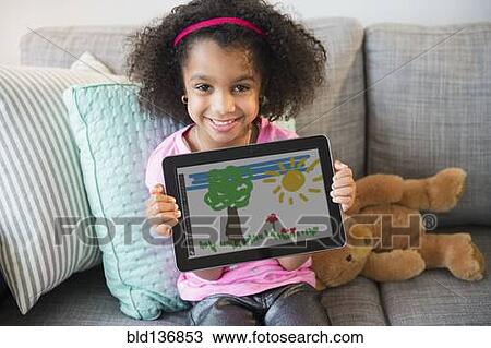 African American girl showing drawing on tablet computer View Large Photo Image Stock Image - African American girl showing drawing on tablet computer. Fotosearch