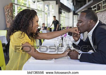 African American man kissing girlfriend's hand in restaurant View Large Photo Image Stock Photograph - African American man kissing girlfriend's hand in restaurant. Fotosearch