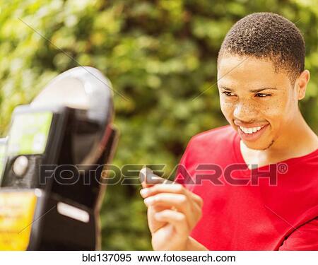 African American man paying parking meter View Large Photo Image Stock Photography - African American man paying parking meter. Fotosearch